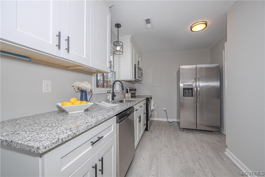 4629 Twelveoaks Road Midlothian, VA 23112 - Photo 7 of 23 a kitchen with stainless steel appliances granite countertop a sink stove and cabinets