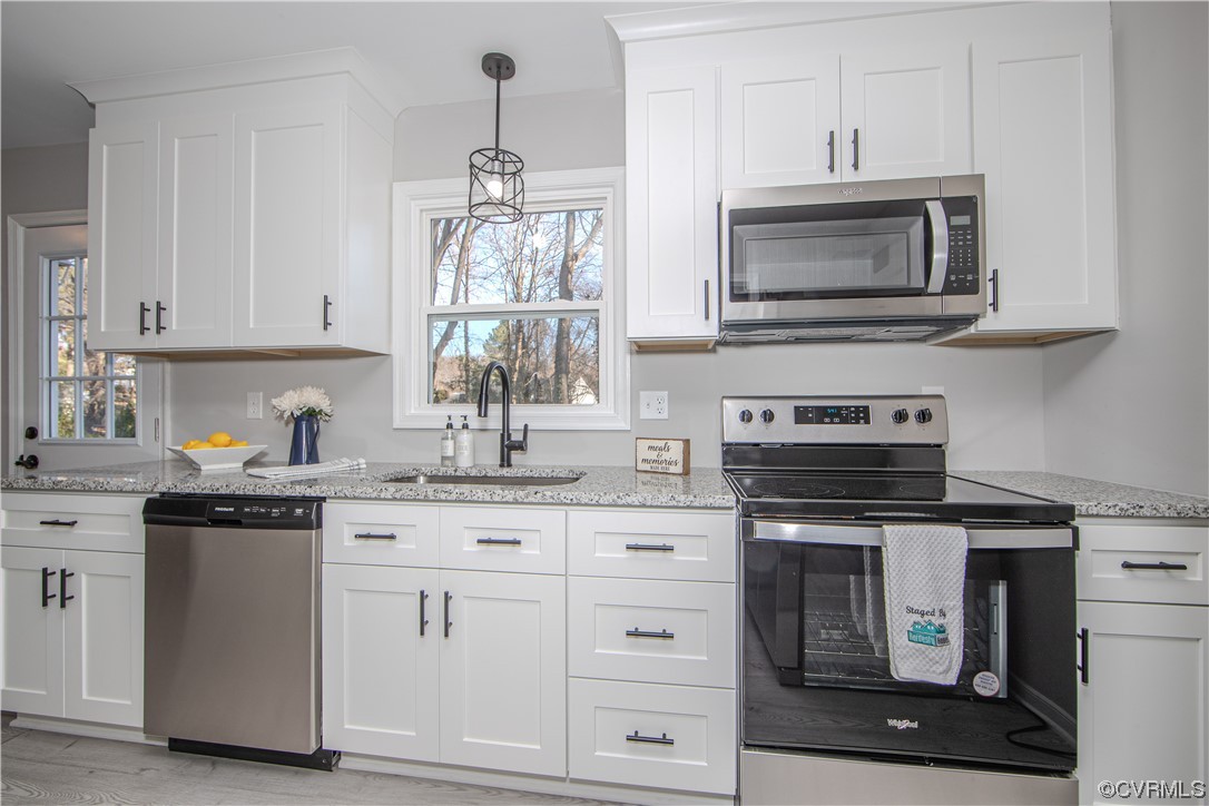 4629 Twelveoaks Road Midlothian, VA 23112 - Photo 8 of 23 a kitchen with white cabinets and appliances
