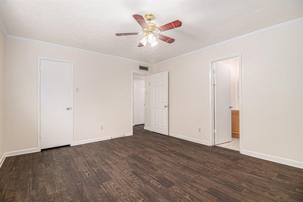 1814 Addington Drive Carrollton, TX 75007 - Photo 15 of 24 Spare room featuring ornamental molding, ceiling fan, and dark wood-type flooring