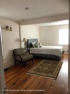 a room with wooden floor and furniture