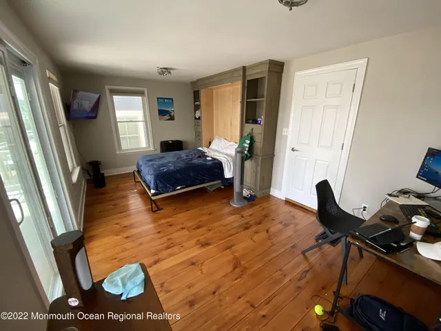 a room with wooden floor and furniture