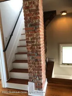 a living room with furniture rug and wooden floor