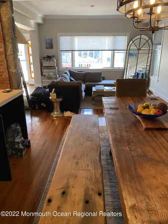 a living room with furniture window and wooden floor