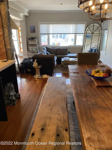 a living room with furniture window and wooden floor