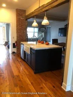 a view of a kitchen with a table and chairs in it