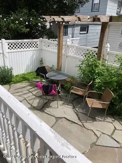 a view of a backyard with sitting area