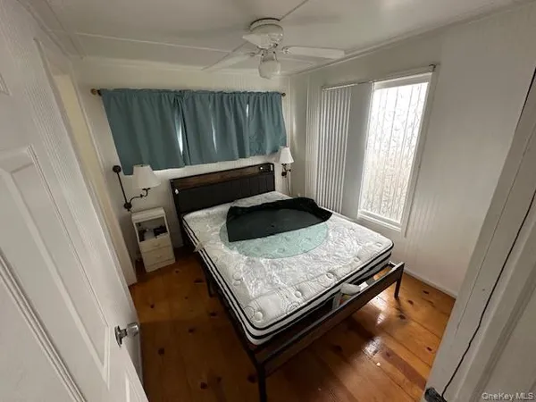 a living room with wooden floor and furniture