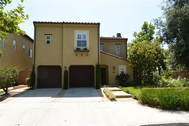 a house that has a tree in front of it