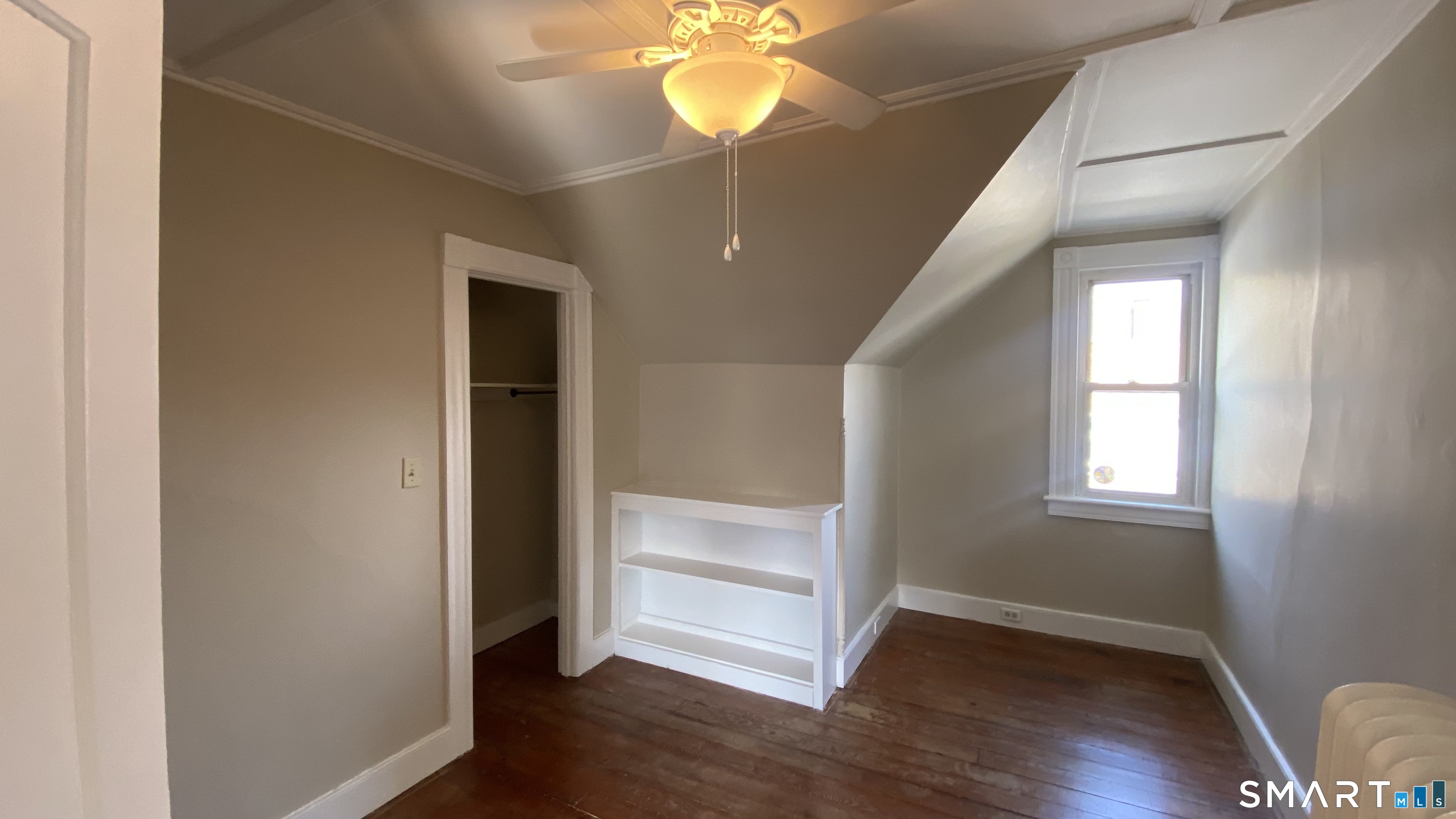 88 Belleview Avenue Torrington, CT 06790 - Photo 12 of 26 an empty room with wooden floor fan and window