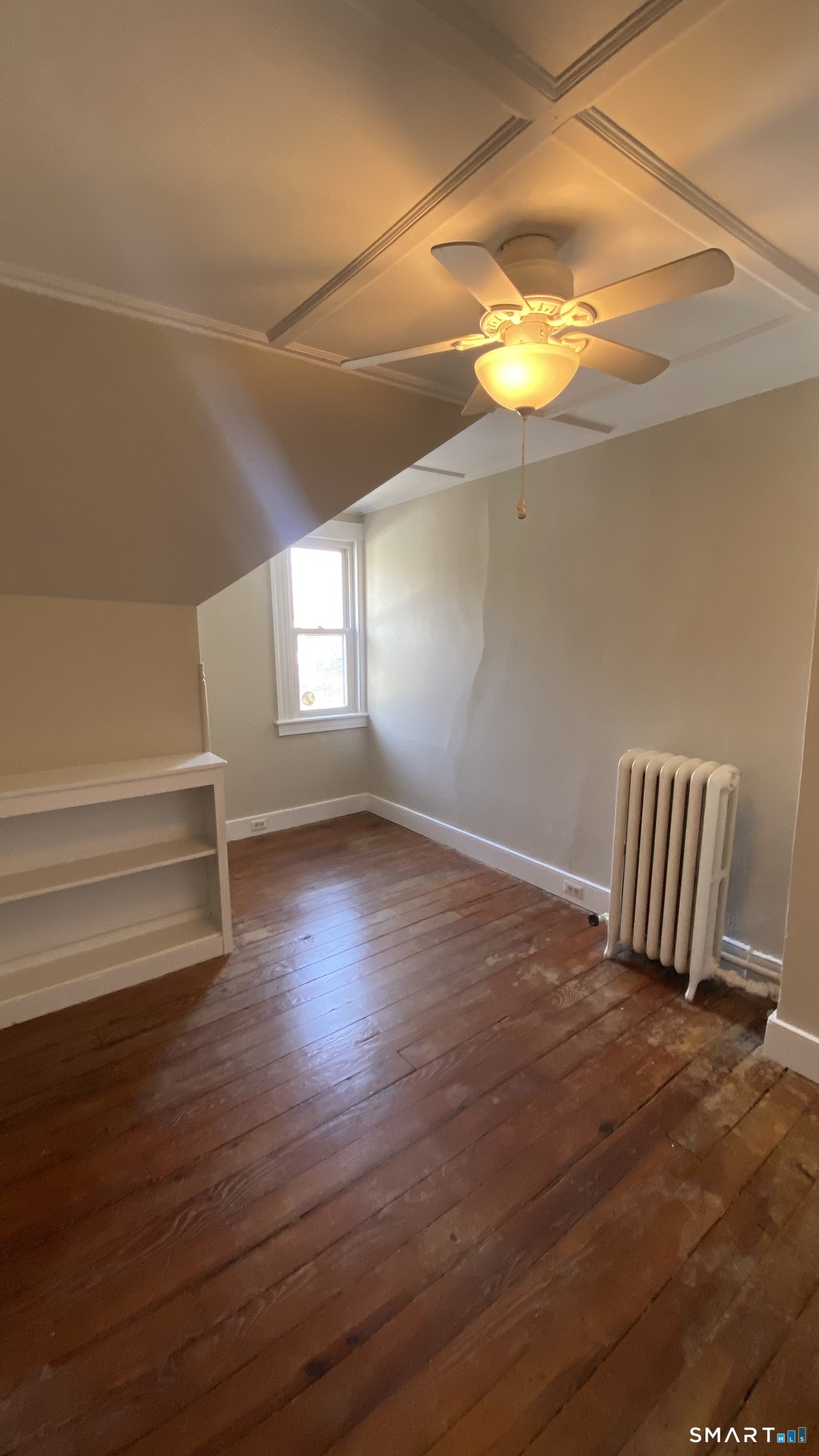 88 Belleview Avenue Torrington, CT 06790 - Photo 13 of 26 a view of empty room with wooden floor and fan