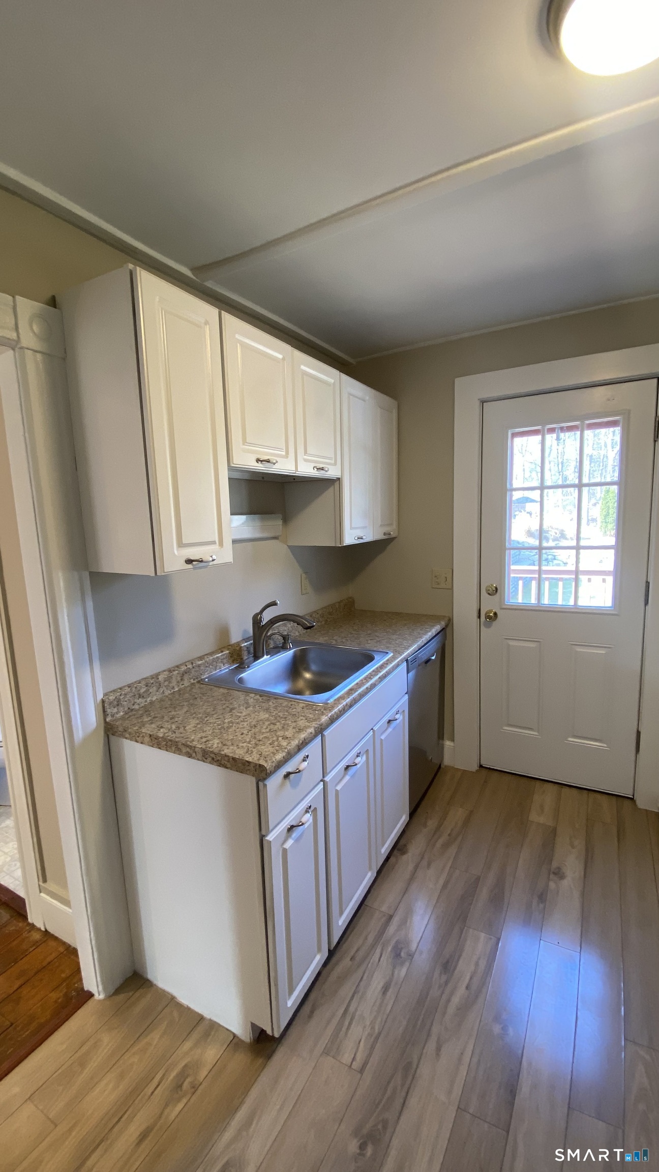 88 Belleview Avenue Torrington, CT 06790 - Photo 5 of 26 a kitchen with stainless steel appliances granite countertop wooden floors and white walls