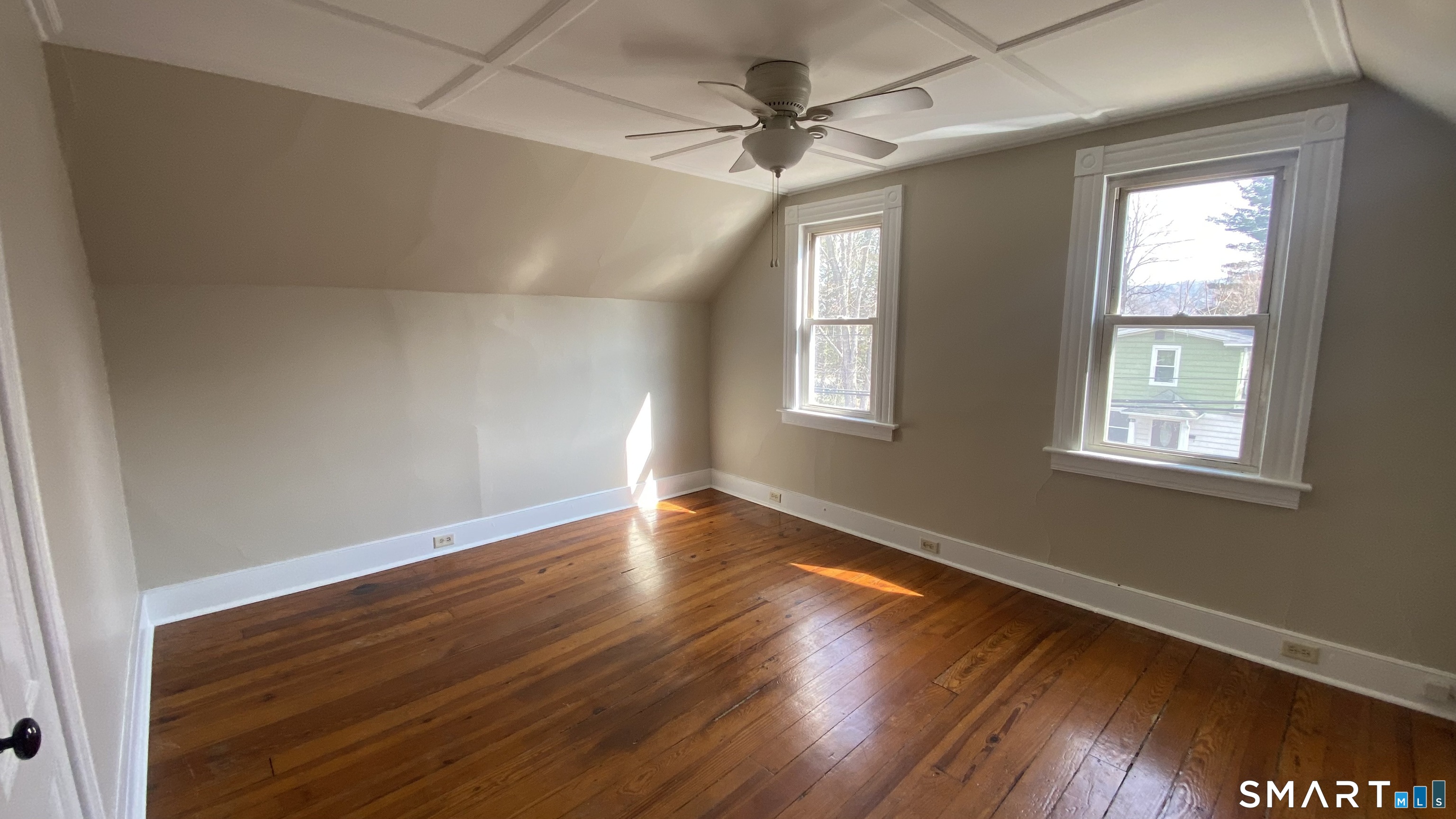 88 Belleview Avenue Torrington, CT 06790 - Photo 7 of 26 a view of an empty room with wooden floor and a window