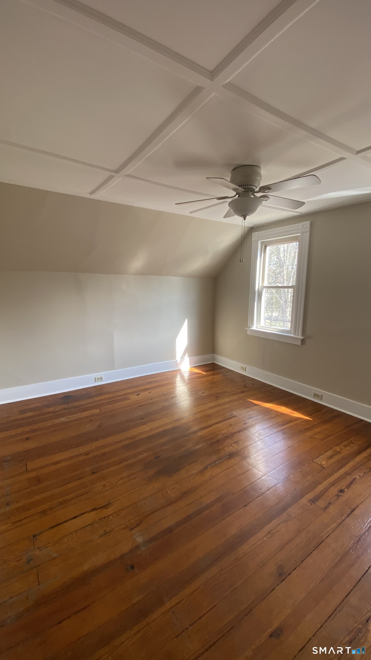 88 Belleview Avenue Torrington, CT 06790 - Photo 8 of 26 an empty room with wooden floor and windows