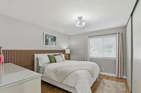 a bedroom with a bed and a table