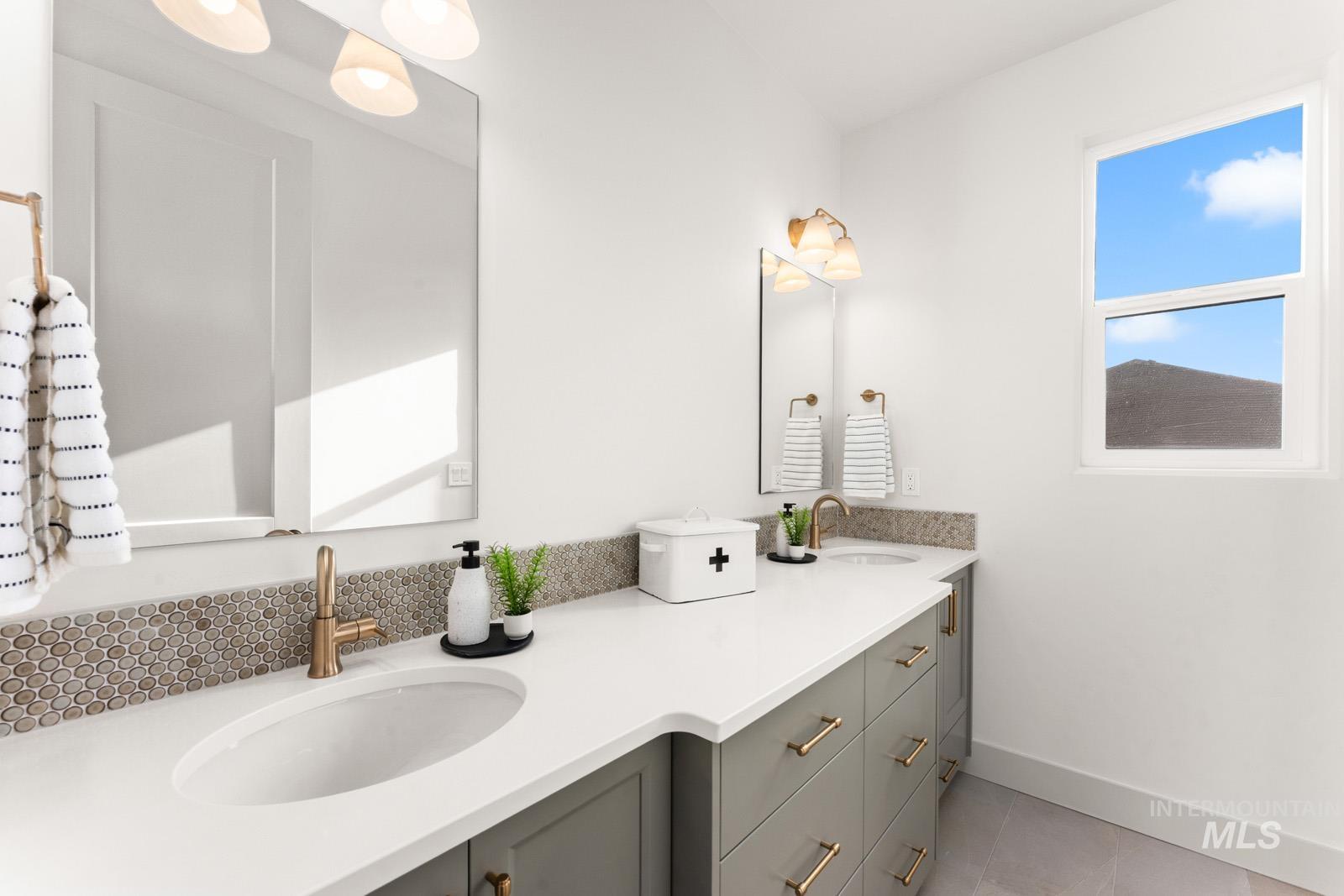 6169 East Prominence Court Boise, ID 83716 - Photo 31 of 43 Bathroom featuring double vanity and light tile patterned flooring
