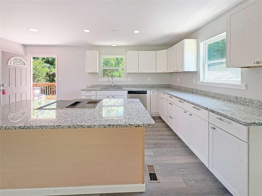 24 George Street Forsyth, GA 31029 - Photo 14 of 17 a kitchen with granite countertop a sink and a counter top space