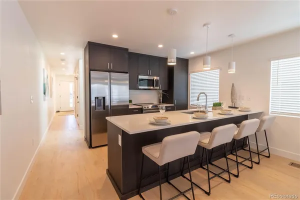 a large kitchen with a table and chairs
