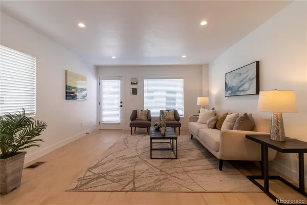 a living room with furniture and a potted plant