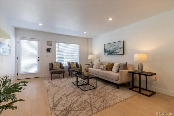 a living room with furniture and a lamp