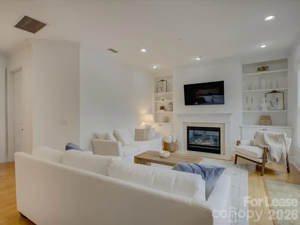 a living room with furniture and a potted plant