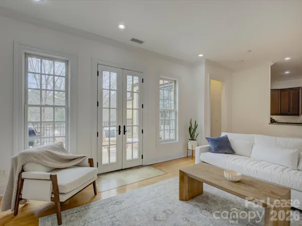 a roof deck with couches and wooden floor