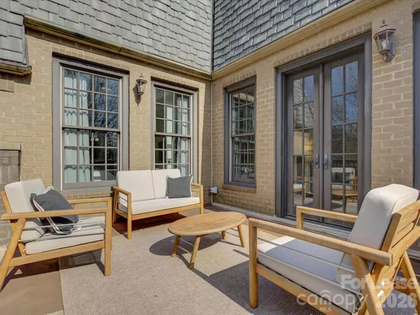 a roof deck with a table and chairs
