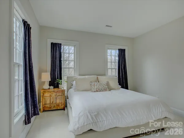a bedroom with a large bed and a window
