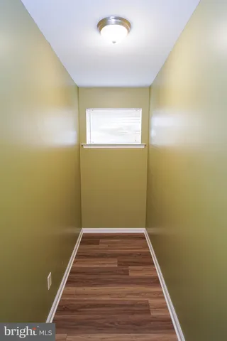 a view of a room with wooden floor and a carpet