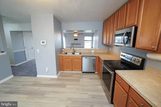 a kitchen with a stove top oven sink and cabinets