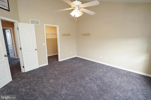 a view of a chandelier fan and a refrigerator