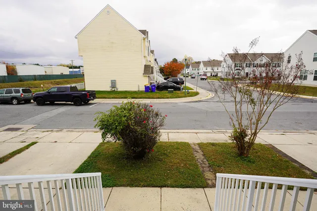 a view of a street with cars parked