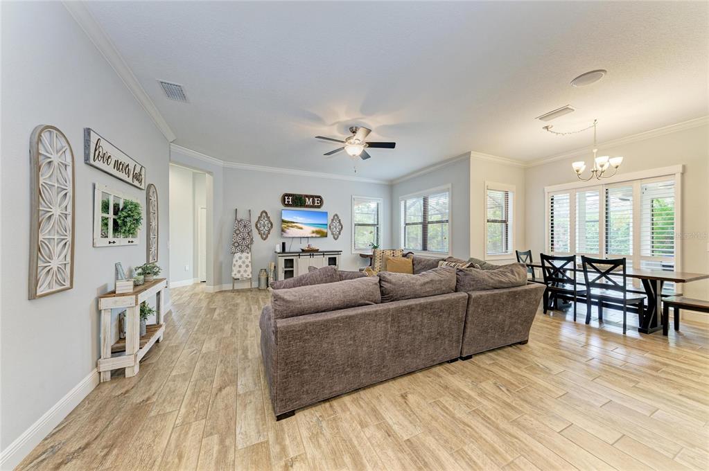 12642 Harney Street Venice, FL 34293 - Photo 21 of 85 a living room with furniture and a wooden floor