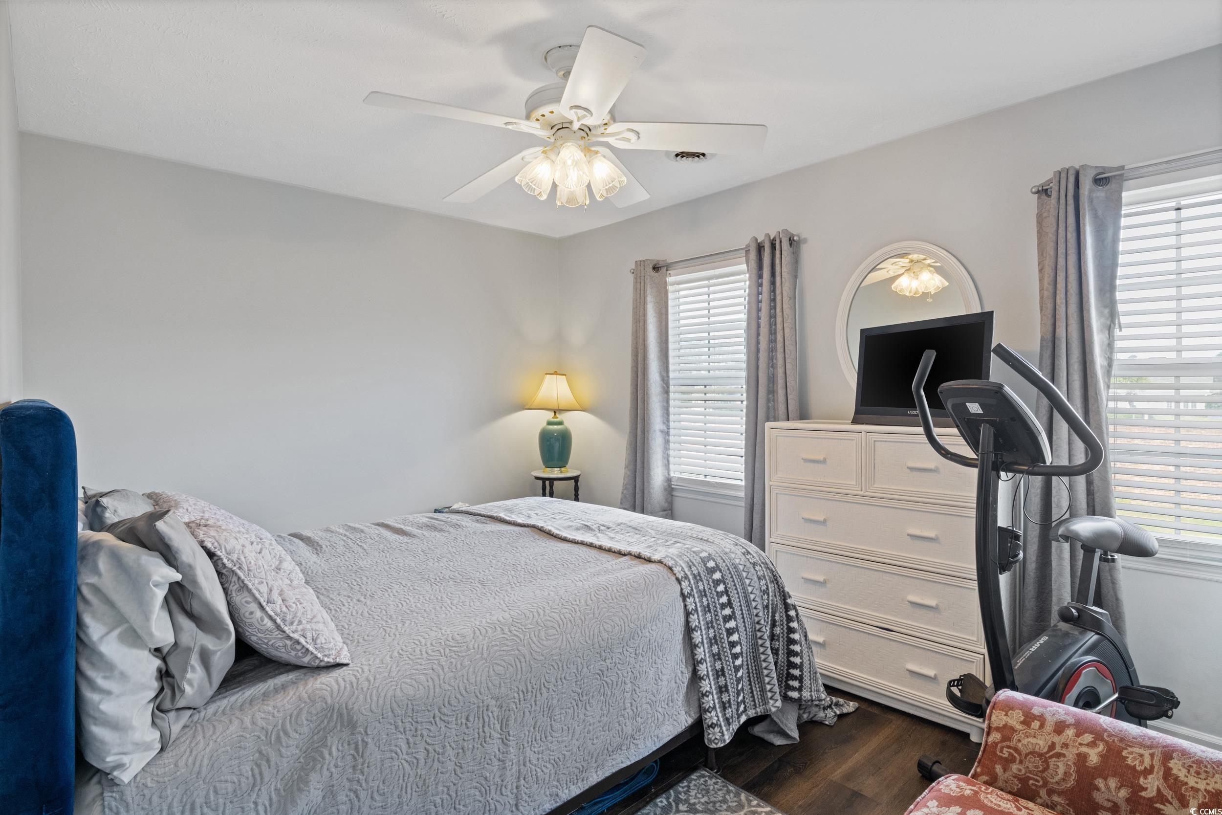 830 44th Avenue North, Unit S4 Myrtle Beach, SC 29577 - Photo 12 of 31 Bedroom with dark wood-style flooring and ceiling fan