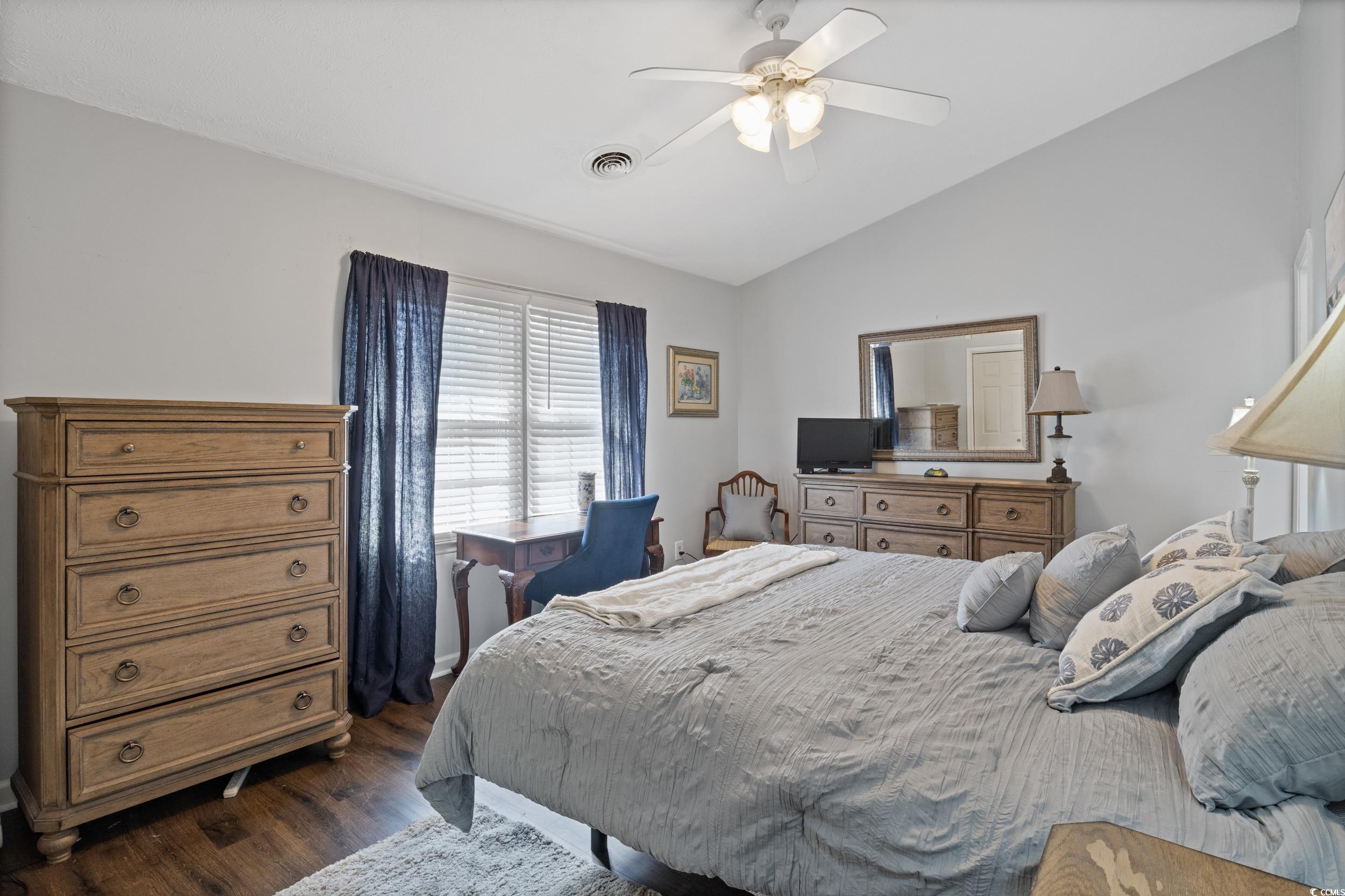 830 44th Avenue North, Unit S4 Myrtle Beach, SC 29577 - Photo 16 of 31 Bedroom with vaulted ceiling, dark wood-style flooring, and a ceiling fan