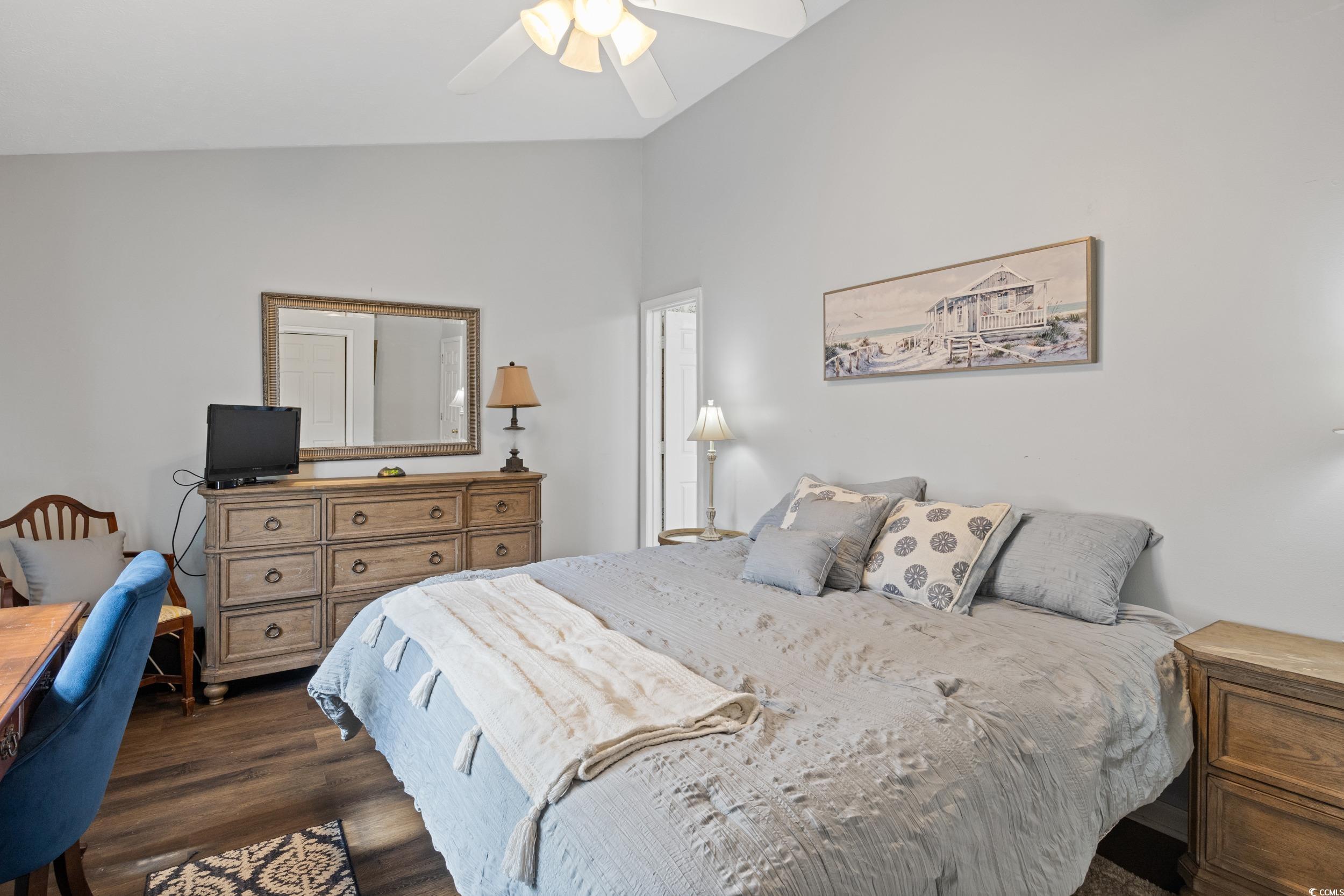 830 44th Avenue North, Unit S4 Myrtle Beach, SC 29577 - Photo 17 of 31 Bedroom featuring dark wood-style flooring, vaulted ceiling, and a ceiling fan