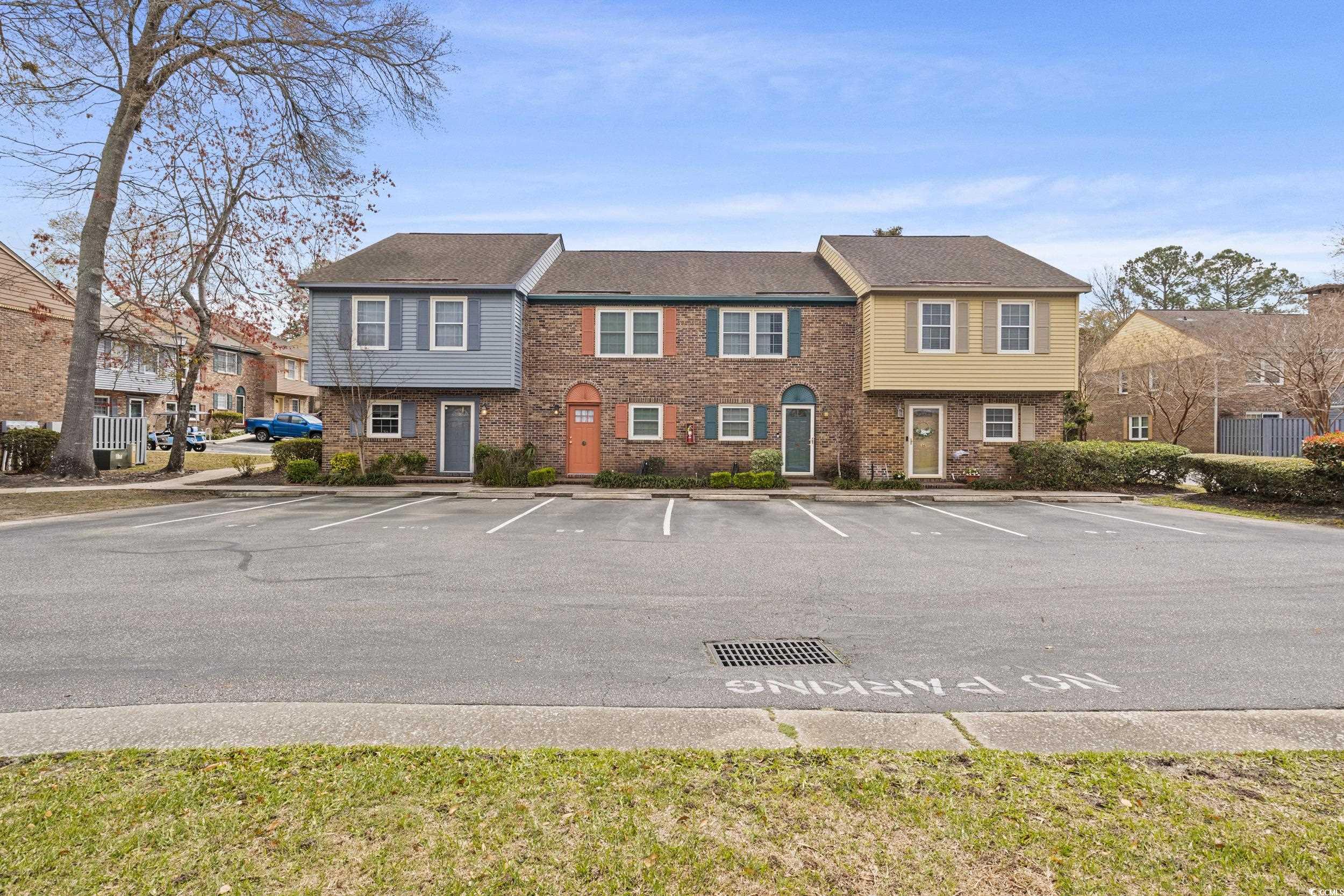 830 44th Avenue North, Unit S4 Myrtle Beach, SC 29577 - Photo 26 of 31 View of front of property featuring brick siding and uncovered parking
