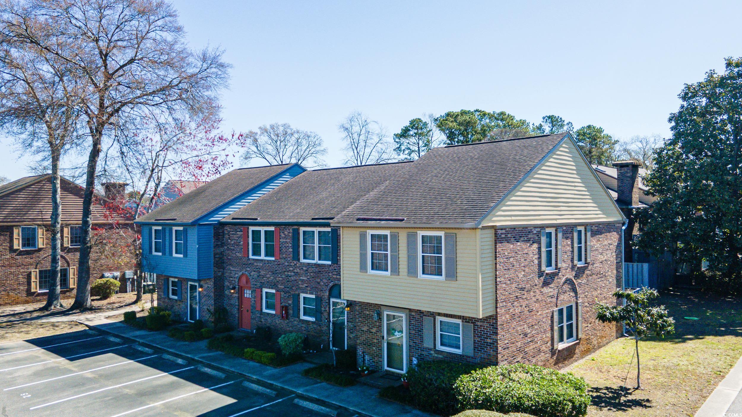 830 44th Avenue North, Unit S4 Myrtle Beach, SC 29577 - Photo 28 of 31 View of front of house with uncovered parking and brick siding
