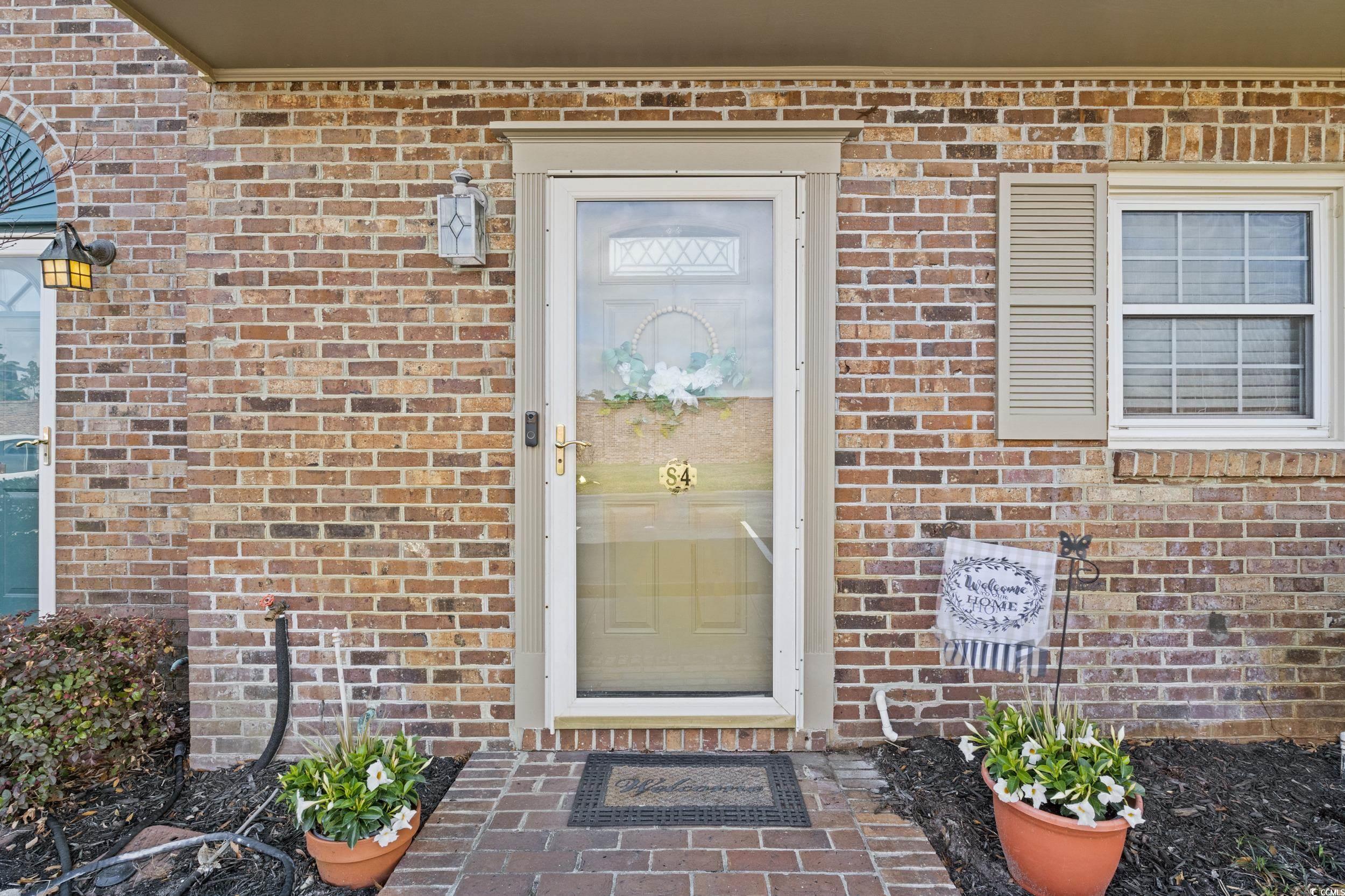 830 44th Avenue North, Unit S4 Myrtle Beach, SC 29577 - Photo 29 of 31 Entrance to property featuring brick siding