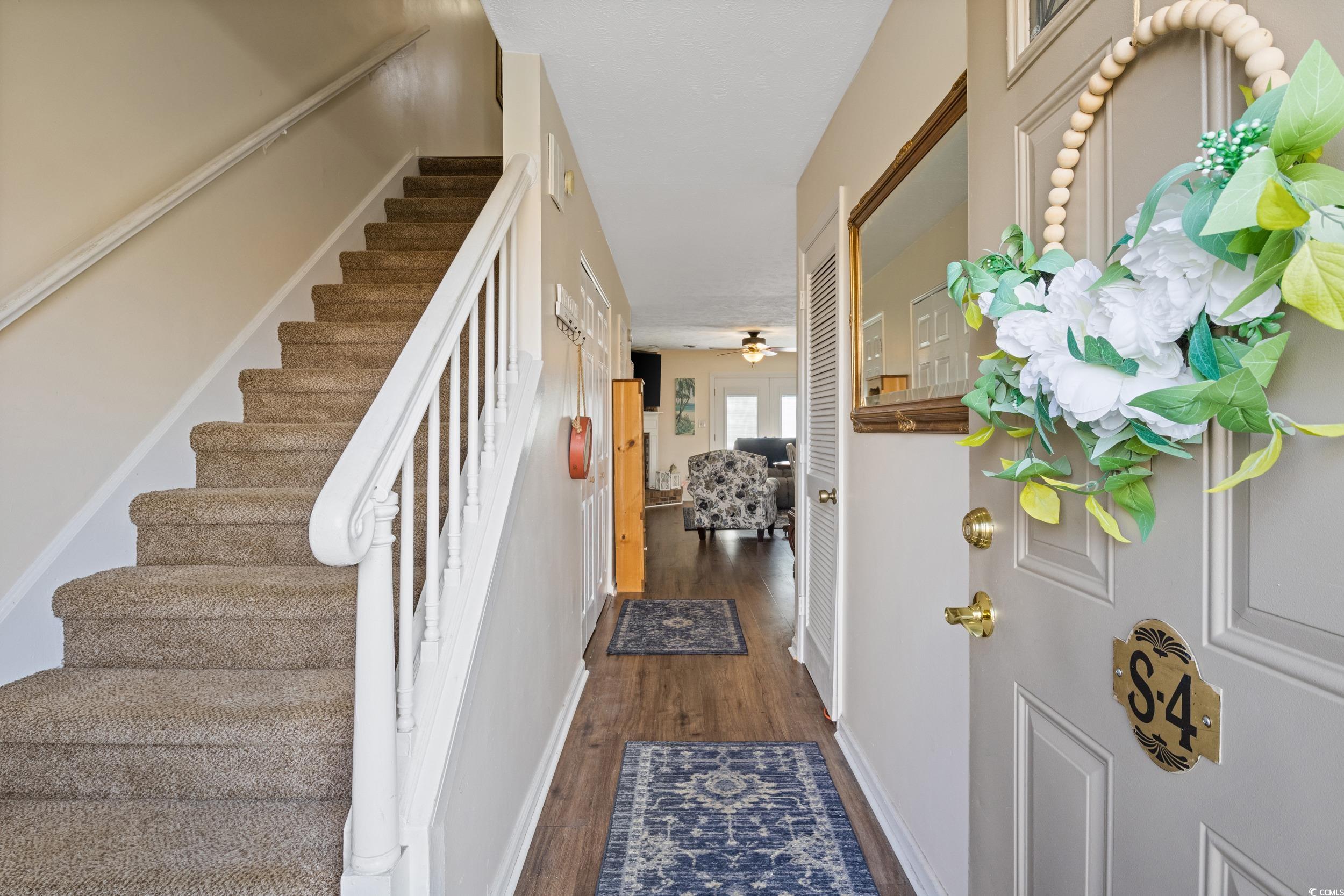 830 44th Avenue North, Unit S4 Myrtle Beach, SC 29577 - Photo 30 of 31 Entryway featuring dark wood-style flooring, stairs, and ceiling fan