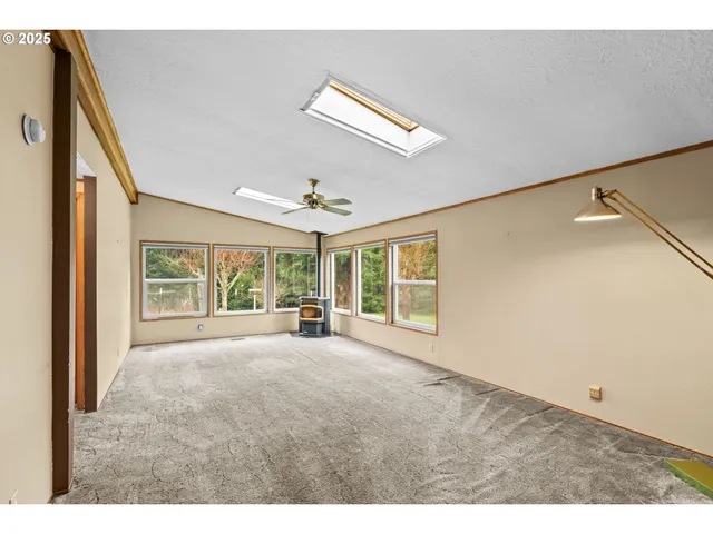 a big room with wooden floor and windows