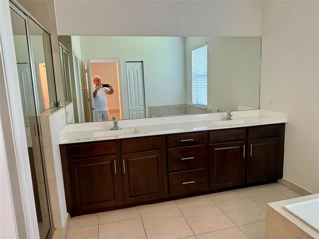 a bath tub sitting in a bathroom next to a window