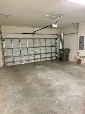 a view of a house with a yard potted plants and a table