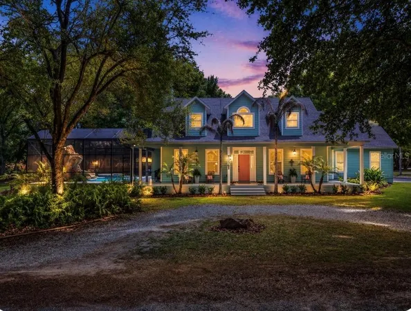 a front view of a house with a yard and outdoor seating