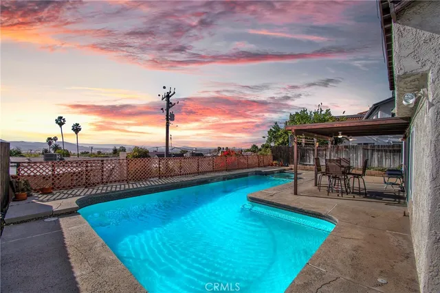 a view of a house with backyard and sitting area