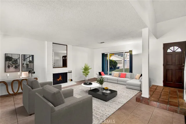 a living room with furniture a fireplace and a table