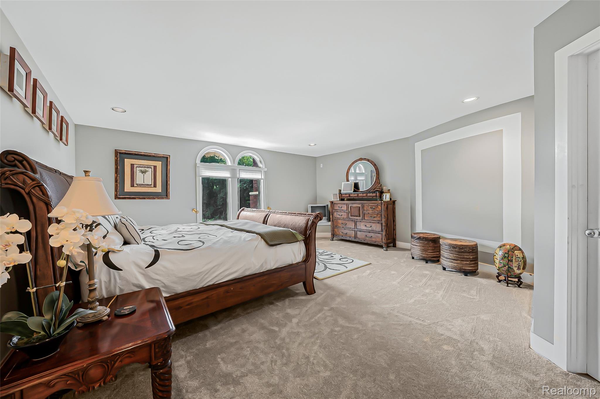 2785 Cranbrook Ridge Court Rochester, MI 48306 - Photo 63 of 99 Spacious room with light gray walls, recessed lighting, carpet flooring, and arched windows