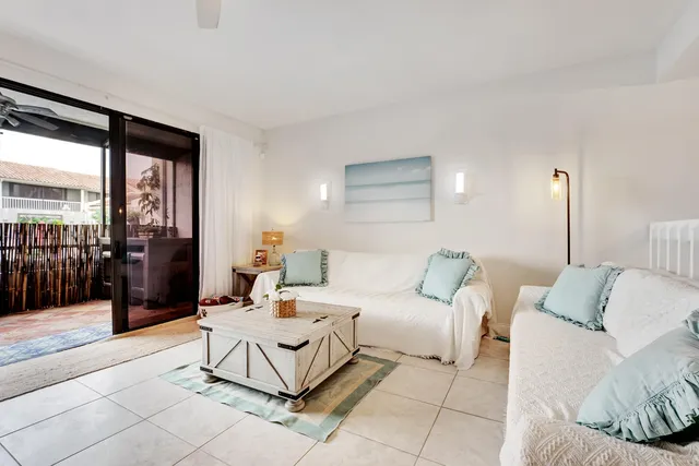 a living room with furniture and a floor to ceiling window