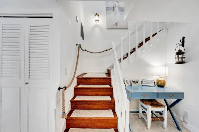 a view of a livingroom with wooden floor and stairs