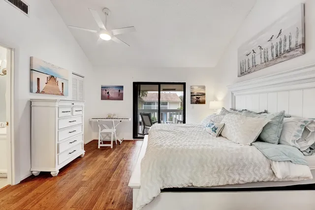 a bedroom with a large bed and a large window