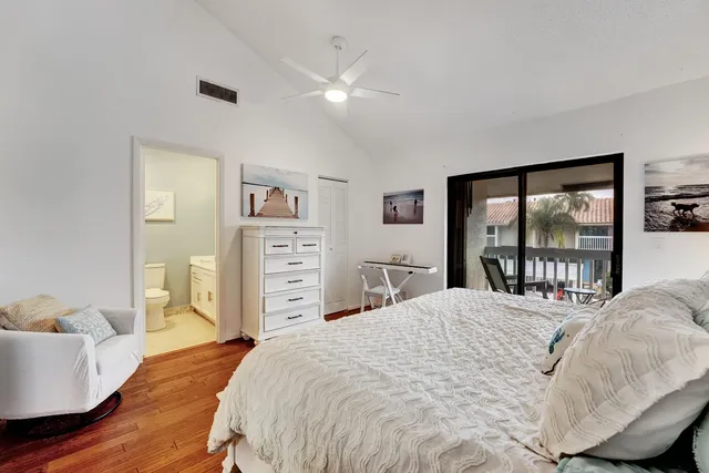 a bedroom with a large bed and a painting on the wall